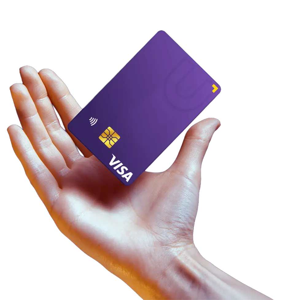 A hand holding a U Visa Prepaid Card