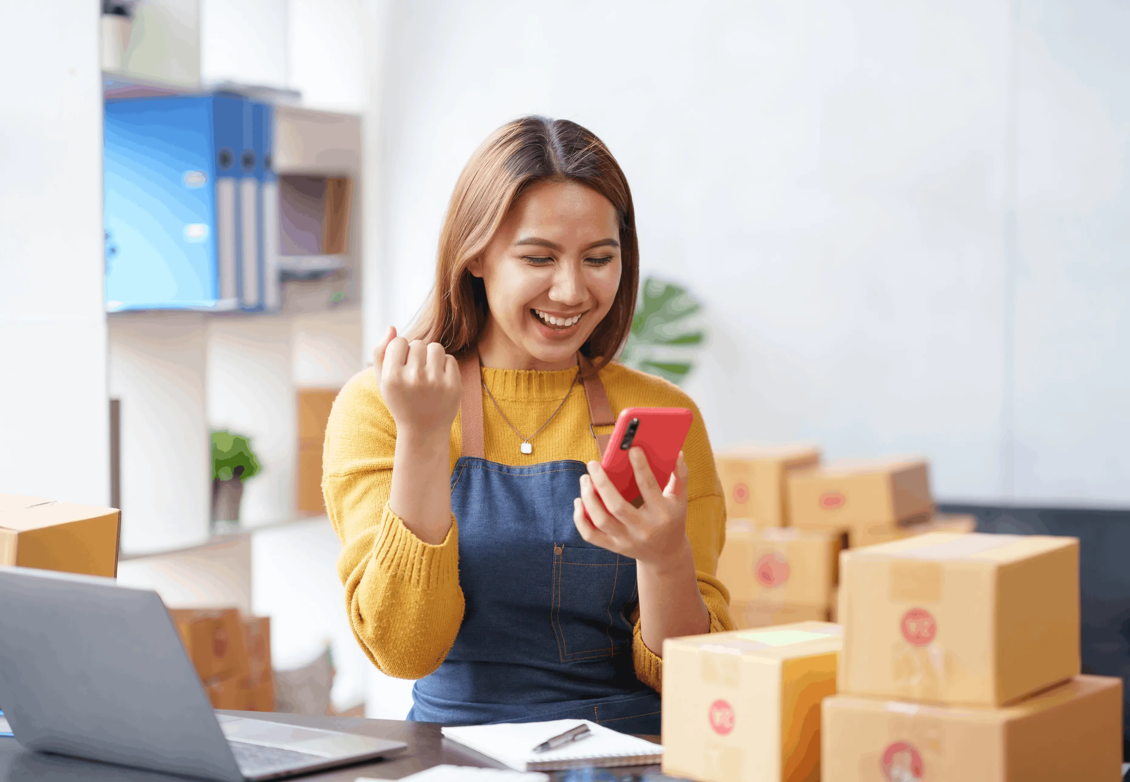 Woman using the U Mobile App while managing packages