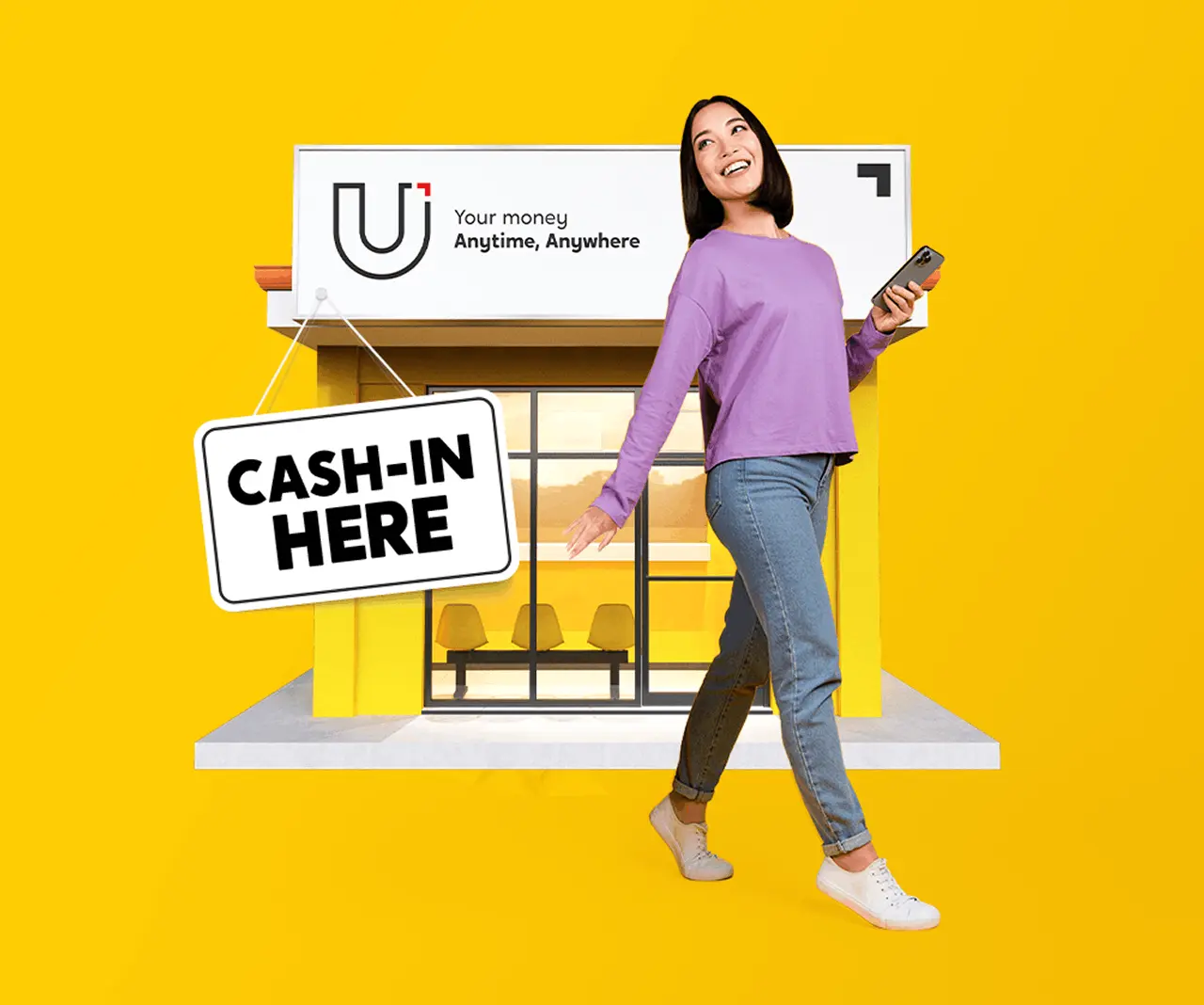 A woman holding a phone standing in front of a U Store with the sign Cash-in Here