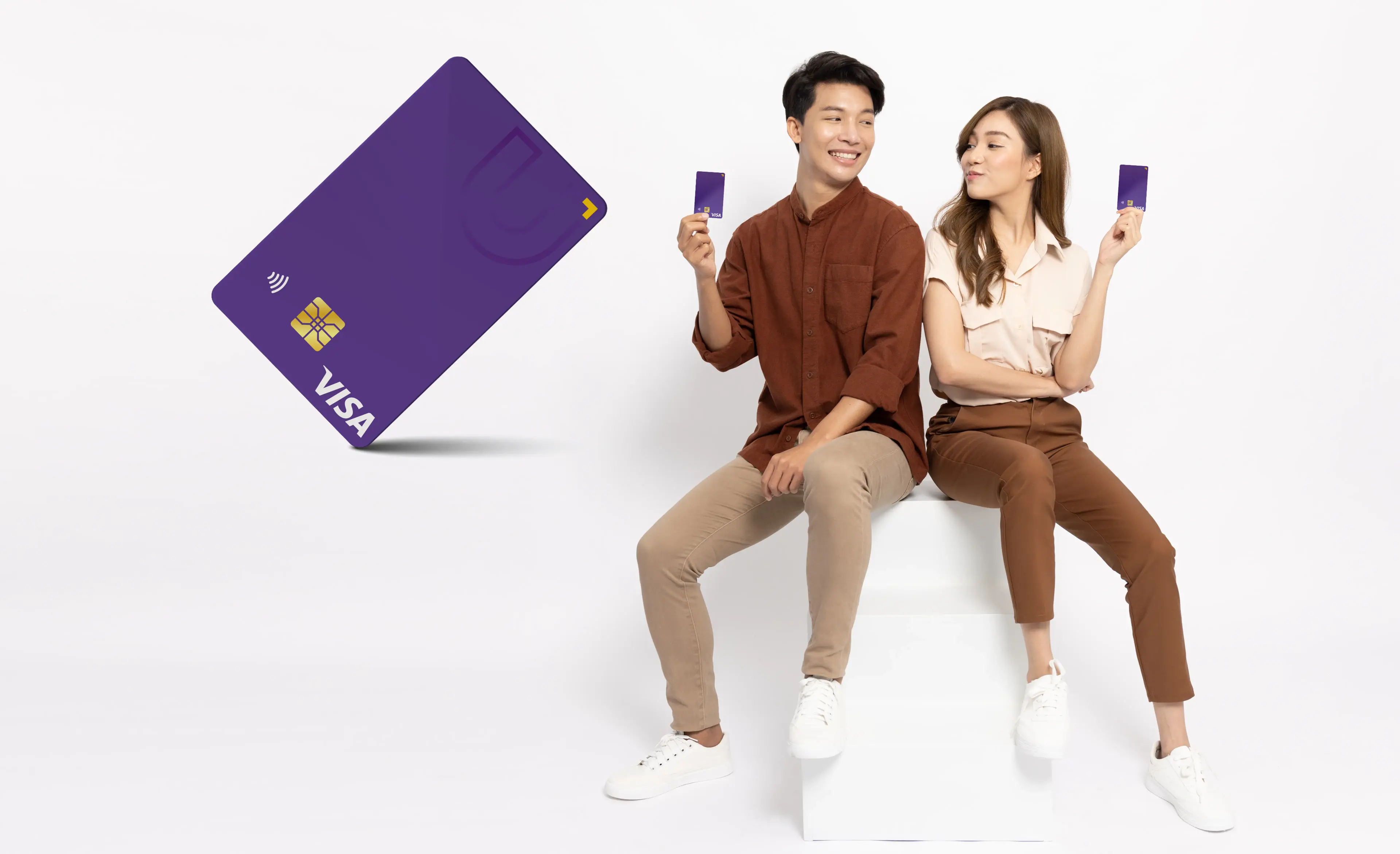 Image of a man and a woman, each holding a U Visa.